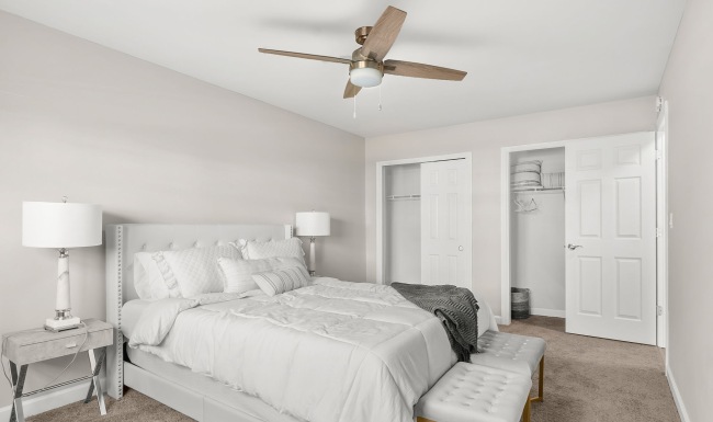 bedroom with bed ceiling fan and lamp