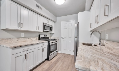 a kitchen with white cabinets