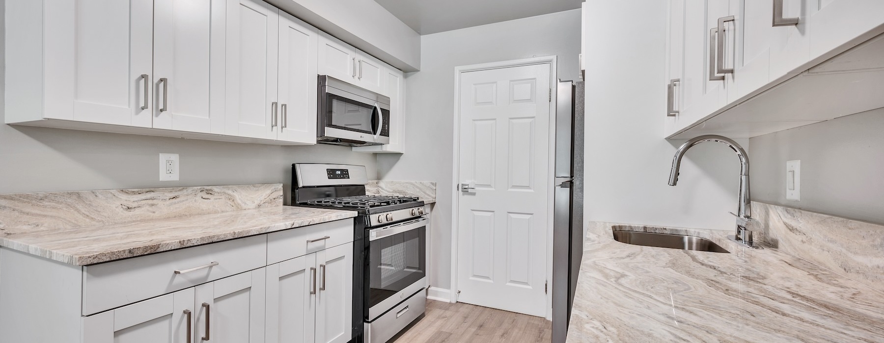 a kitchen with white cabinets