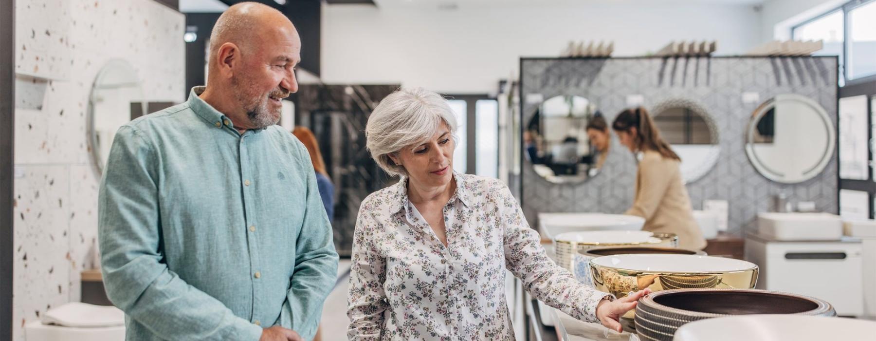 a man and woman shopping for dishes