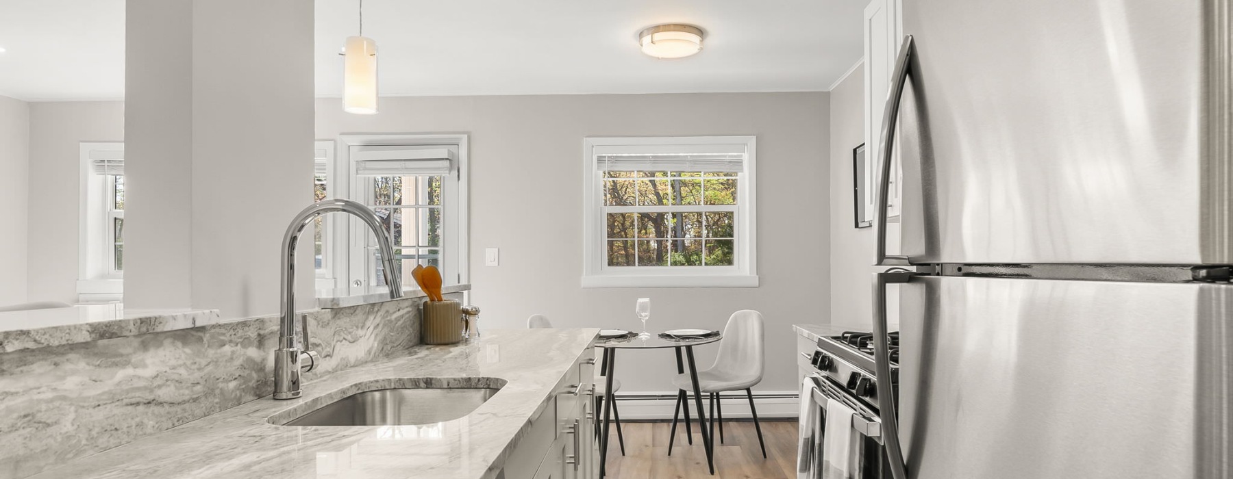 kitchen with stainless steel appliances and dining room in view