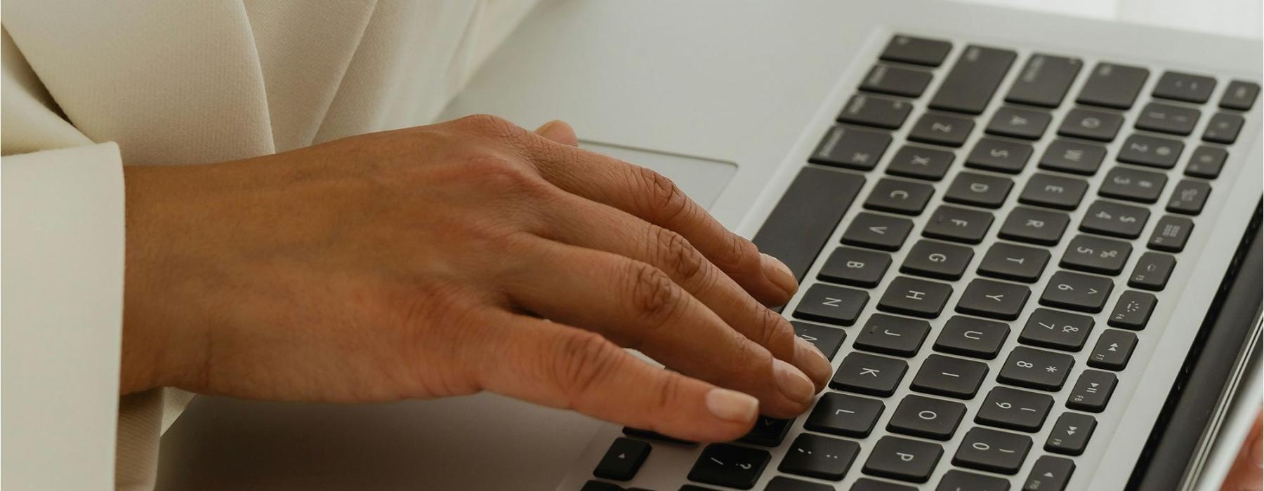 a person typing on a laptop
